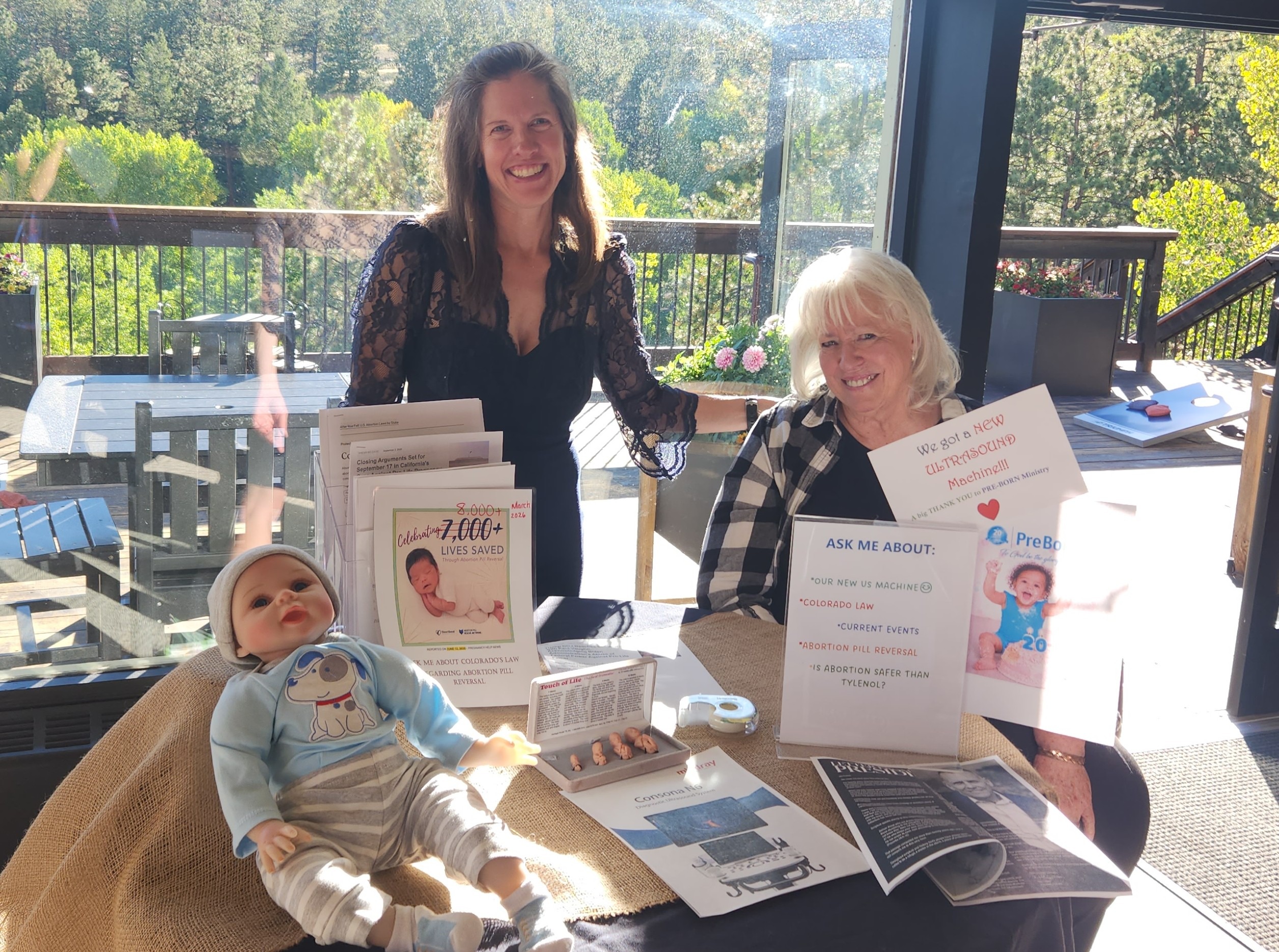 Two BVPC volunteers smiling at the center's information table